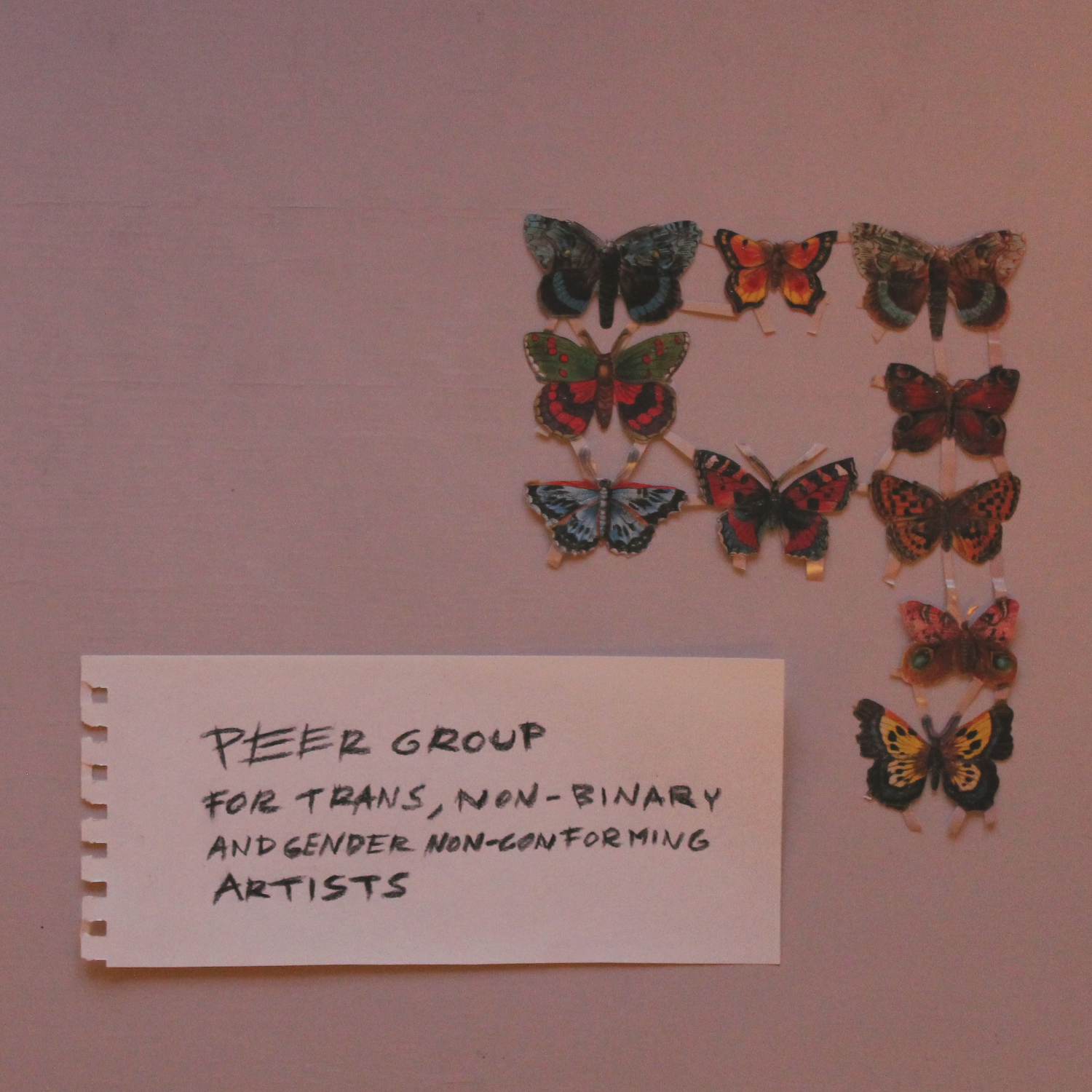 a collage by Pihla Lehtinen, pink background and white piece of paper with the group name written by hand. Above this, paper butterflies of different colours