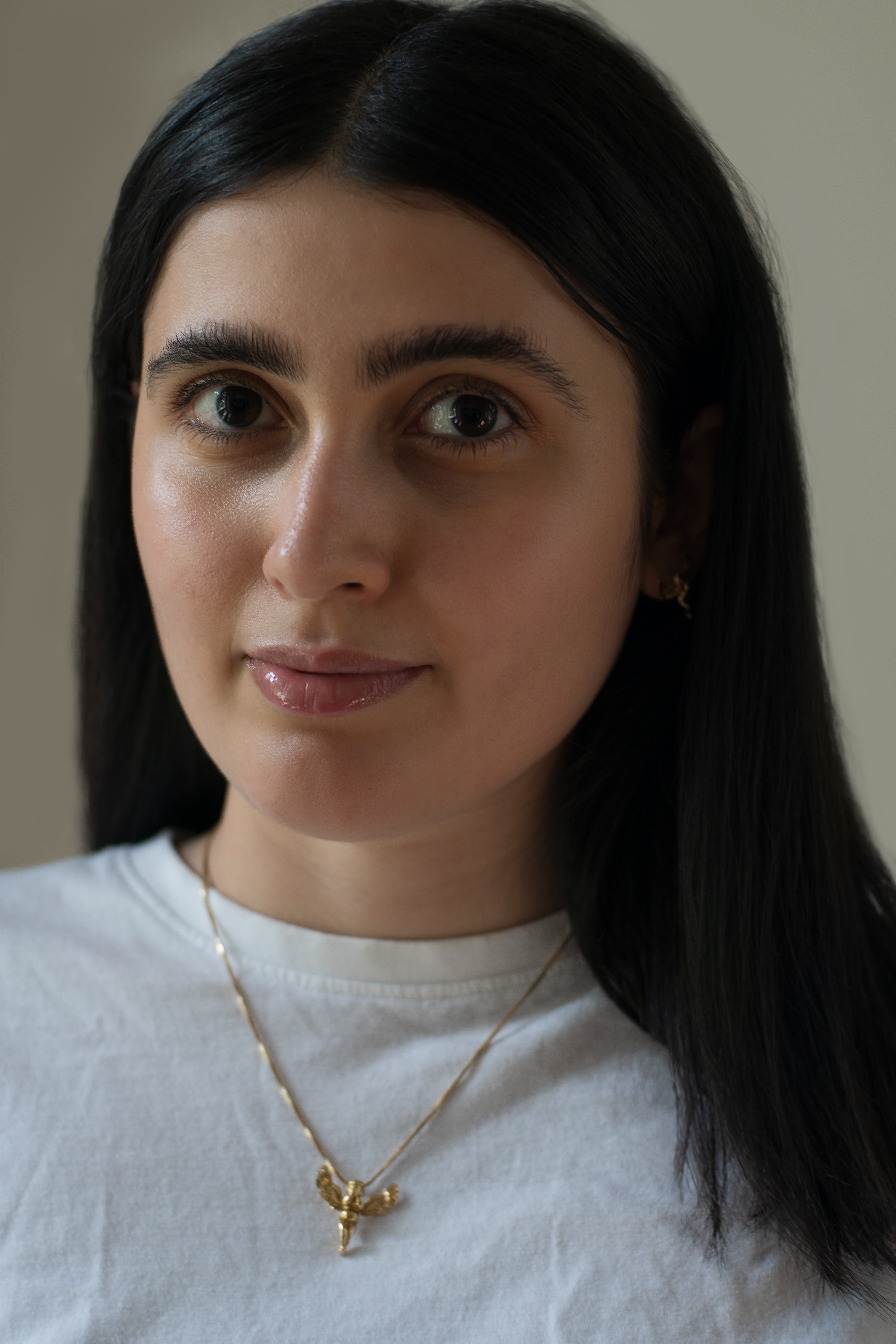 A person with long dark brown hair looking at the camera. 