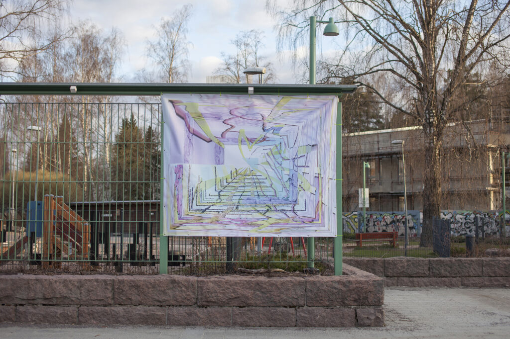 A colourful banner artwork attached to a green fence.